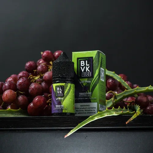 BLVK Aloe grape vape juice bottle and packaging with grapes on a dark background