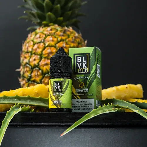 BLVK Aloe Pineapple vape juice bottle and packaging with a pineapple in the background.