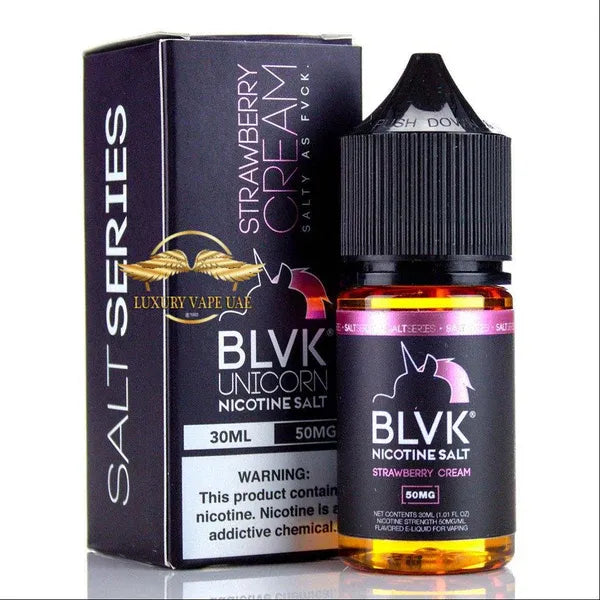 A bottle of BLVK Unicorn Nicotine Salt e-liquid in Strawberry Cream flavor next to its black packaging box, displayed on a reflective white surface.